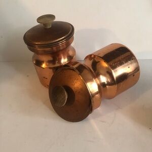 Two vintage small copper canisters with wood knobs on top of lids -well loved
